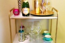13 an IKEA Mulig shelving unit with contact paper and gold spray paint for a glam space