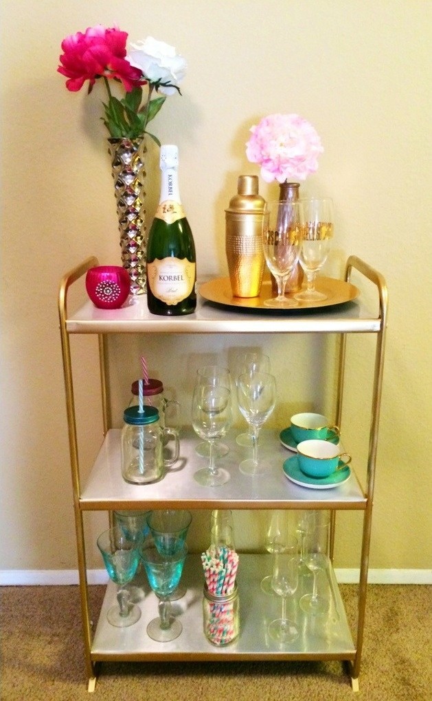 an IKEA Mulig shelving unit with contact paper and gold spray paint for a glam space