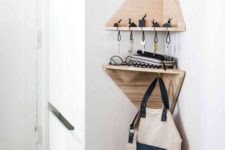 13 tiny geometric corner shelves with a key holder and some hooks are a great idea for a tiny entryway