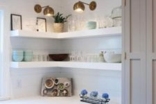 14 white thick corner shelves with additional spotlights are great to save some space in the kitchen