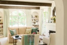 15 a charming living room with wooden beams and an arched doorway that set the tone in the space