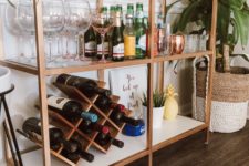 15 an IKEA Vittsjo shelving unit turned into a chic home bar with copper spray paint, the piece features much storage space