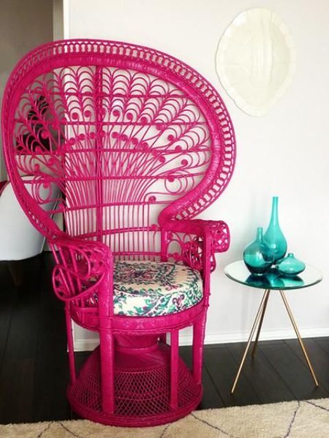 a hot pink peacock chair with a floral print cushion will not only add color but also a boho feel to the space