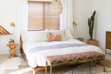 17 a desert boho bedroom with a wicker lamp over the bed to highlight its relaxed boho styling