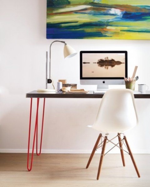 a modern lightweight looking desk made of an IKEA Sanfrid tabletop and bright red hairpin legs