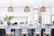 17 rattan stools with blue and white chair covers highlight the nautical design of the kitchen