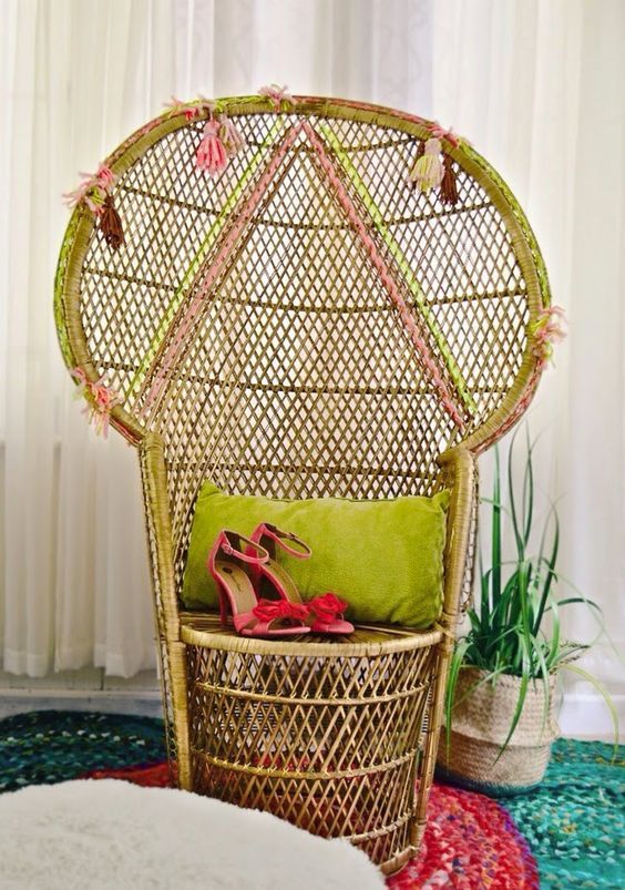 a peacock chair with neon touches, geometric patterns done with yarn and colorful tassels