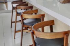 18 bold wood and leather stools spruce up a neutral space and add a bit of drama to the kitchen