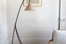 19 a catchy black metal floor lamp with a tiny wicker lampshade for a natural and coastal feel in the space