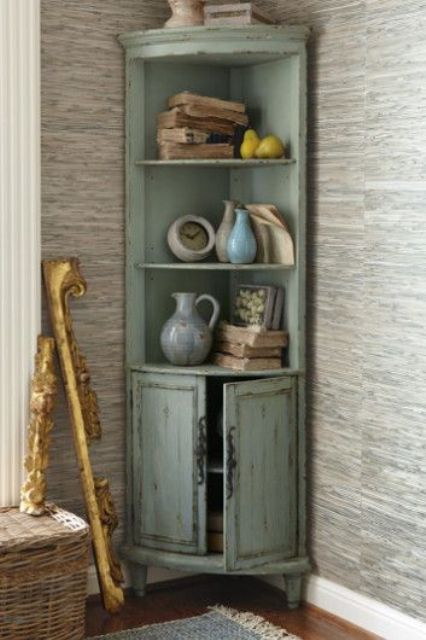 a distressed mint colored corner cabinet will add a refined touch to your space