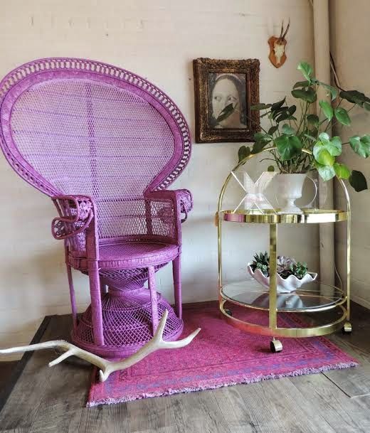 a purple peacock chair and a matching rug is a bright and non-traditional idea