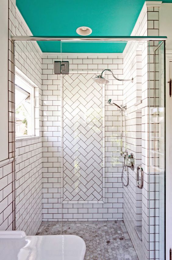 a white shower space with a turquoise ceiling that brightens up the space and makes it more unusual