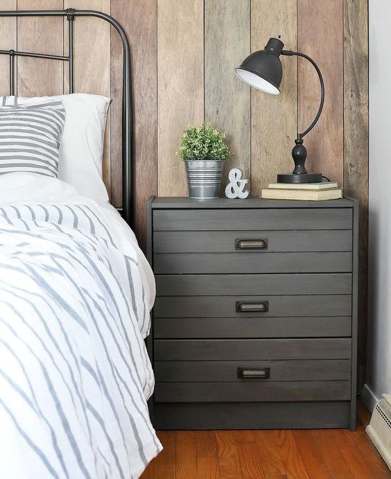 an IKEA Rast dresser hacked with grey paint, planks and vintage handles for an industrial meets rustic bedroom