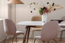 20 an elegant mid-century modern dining space with blush chairs and a wicker floor lamp to add a relaxed feel to the room