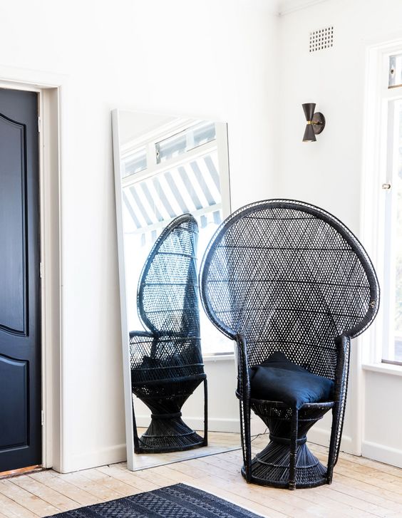 a single black peacock chair with black pillows will match a monochromatic space giving it a slight boho feel