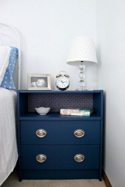 an IKEA Rast dresser painted navy, with contact paper inside and chic metallic knobs