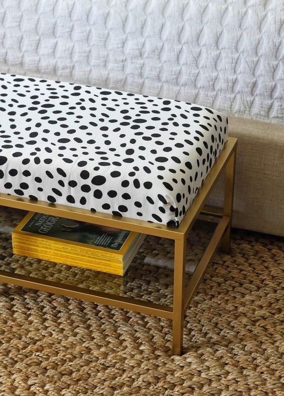 an IKEA Vittsjo table hacked into a chic ottoman with a soft cushion and animal printed fabric on top