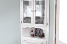 22 squeeze a corner cabinet into a corner of your dining space to maximize storage space here