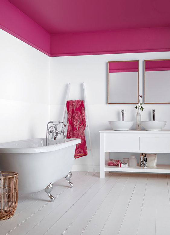 a contemporary bathroom that combines white and fuchsia and looks bright, cheery and bold