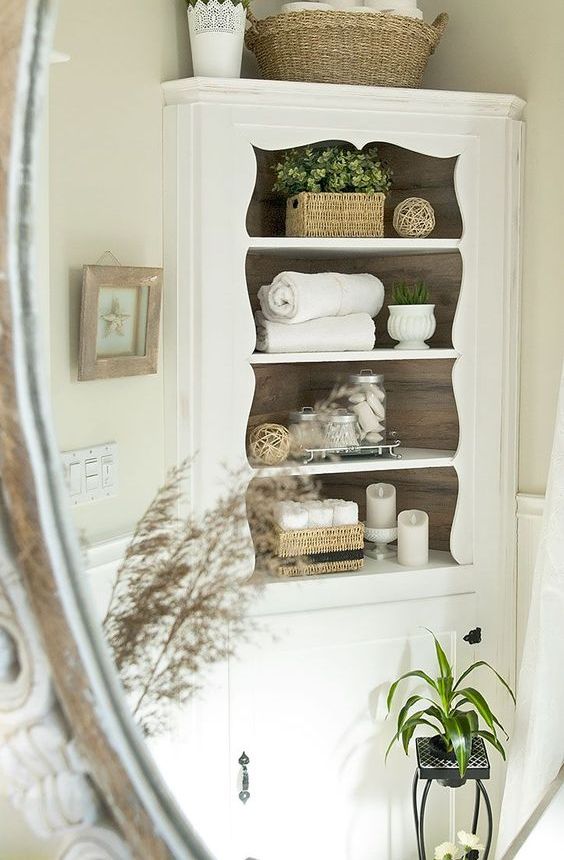 an elegant corner cabinet in white will add a vintage touch to your bathroom and give enough storage space