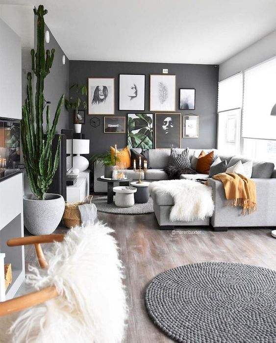 a black statement wall with a gallery wall is a cool and chic focal point for an open layout