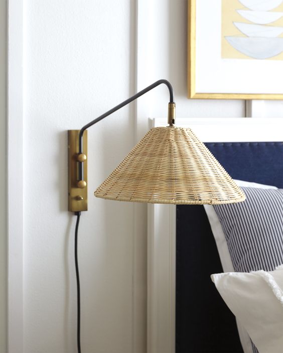 a stylish wall sconce with a wicker lampshade and brass touches will give your bedroom a coastal feel
