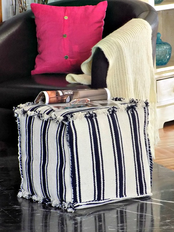 an ottoman or pouf made of striped IKEA rugs - make a cube of plywood and cover it with rugs