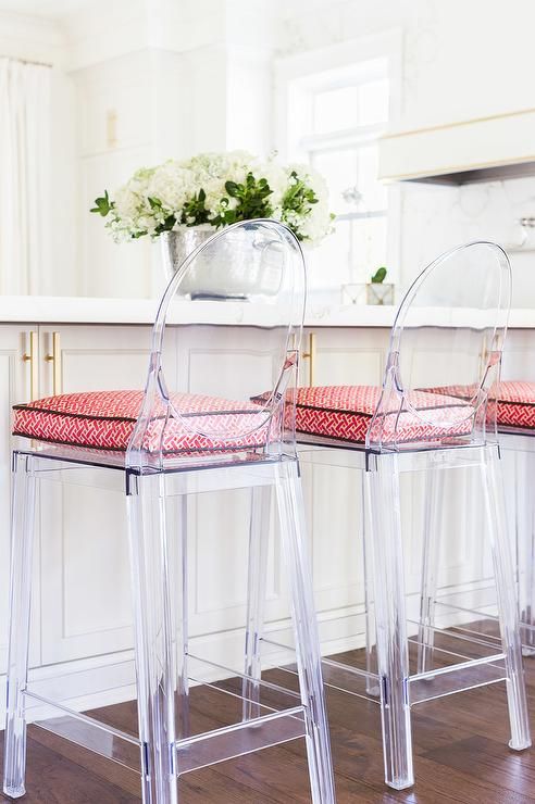 ghost counter stools with bright printed cushions on the seats are trendy and modern to refresh a vintage kitchen island
