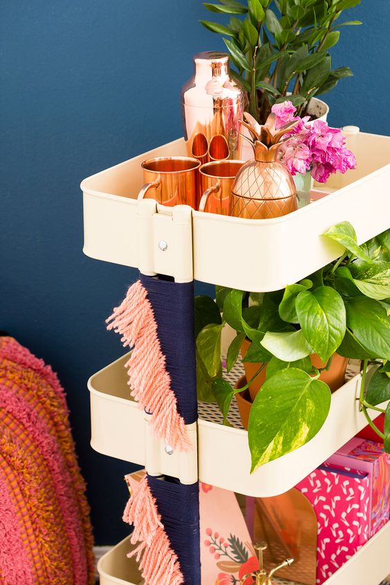 IKEA Raskog cart refreshed with navy and pink fringe on its sides is a great idea for a boho space