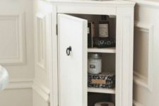 25 a stylish tiny corner cabinet like this one will give you more storage space in a bathroom