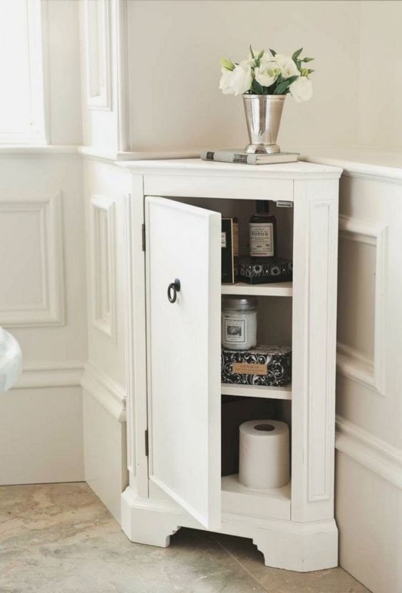 a stylish tiny corner cabinet like this one will give you more storage space in a bathroom