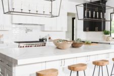 25 wooden kitchen stools with black metal legs add texture to the space and warm up the white interior a bit