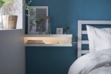 26 IKEA Mosslanda ledges turned into a floating nightstand with lights, which is ideal for a small bedroom