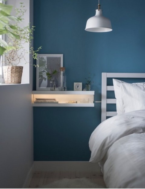 IKEA Mosslanda ledges turned into a floating nightstand with lights, which is ideal for a small bedroom