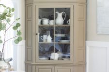 26 a neutral fully closed corner cabinet with some glass to display tableware in your dining space