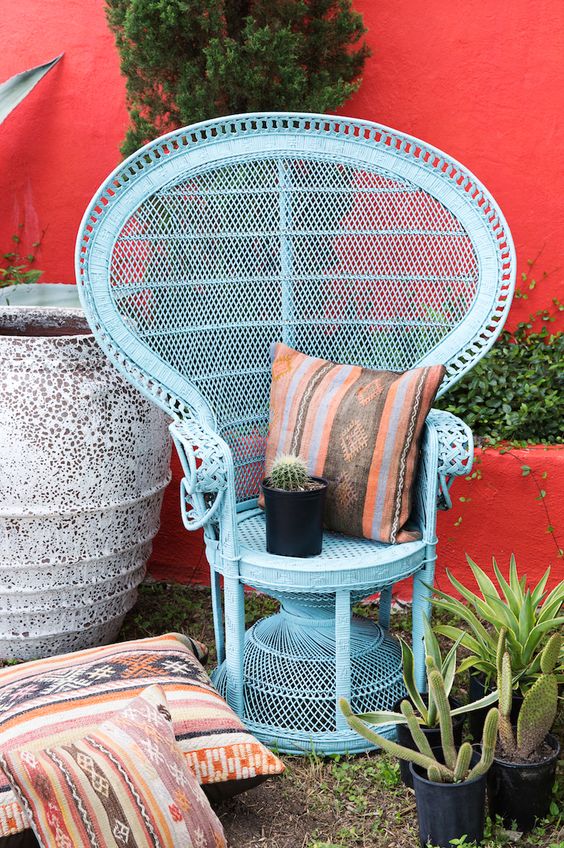 refresh your peacock chair with blue paint and a folksy pillow to make your boho nook more colorful