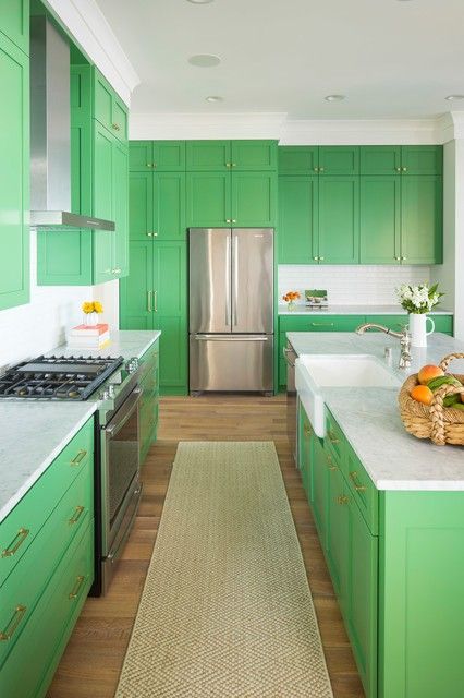 a bright green kitchen with white countertops and neutral handles is a very bold idea