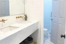a chic modern farmhouse bathroom with white skinny tiles and a mosaic floor is a stylish space with an eye-catchy touch