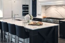a contemporary kitchen with black cabinets, white stone countertops and a matching backsplash plus catchy lamps