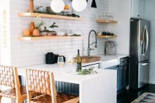 a cool blue and white kitchen with stone countertops, open shelves and a white skinny tile backsplash plus lovely decor