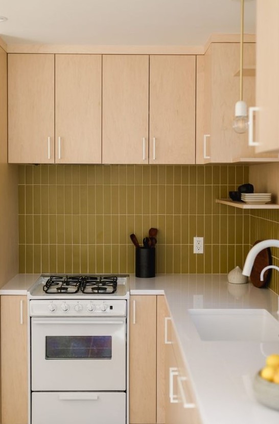 a light colored plywood kitchen with a mustard skinny tile backsplash and white fixtures for a fresh touch