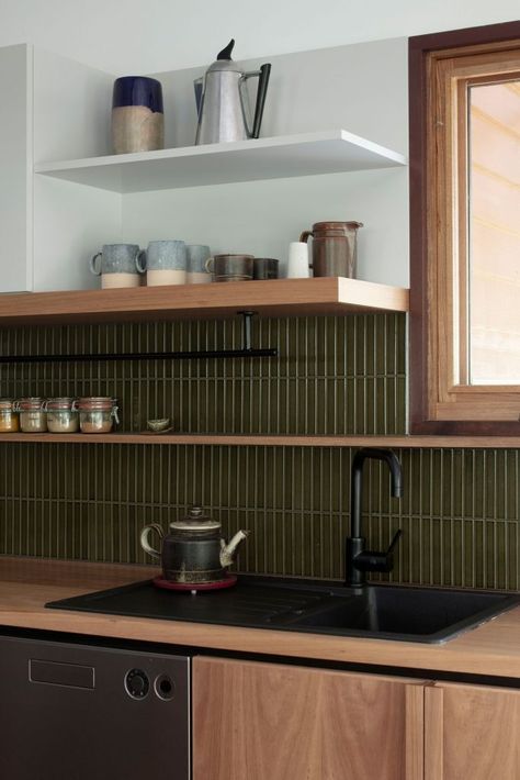 a refined modern kitchen with stained cabinets, green skinny tiles, open shelves, black fixtures is a chic and cool idea
