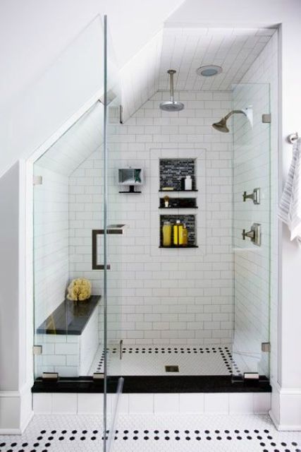 a stylish monochromatic shower with a built-in bench with a black seat that matches the floor and adds drama