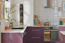 a two-tone kitchen with white and purple cabinets, a white tile backsplash and white countertops is a bold and catchy space