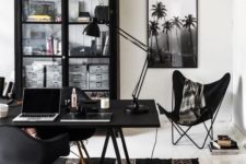 a whimsical black and white home office with black furniture, white as a blank canvas and black and white art