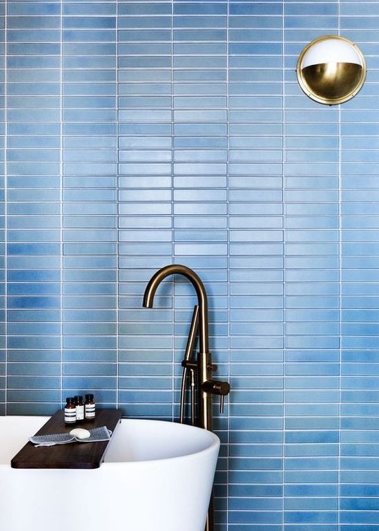 refresh your contemporary bathroom with laconic blue skinny tiles on the wall accented with white grout