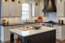 vintage-inspired white cabinetry with dark countertops and a dark kitchen island with a white countertop for a contrast
