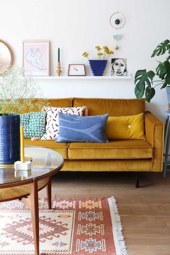 a bright living room done in mustard and shades of blue and navy is a gorgeously bold idea