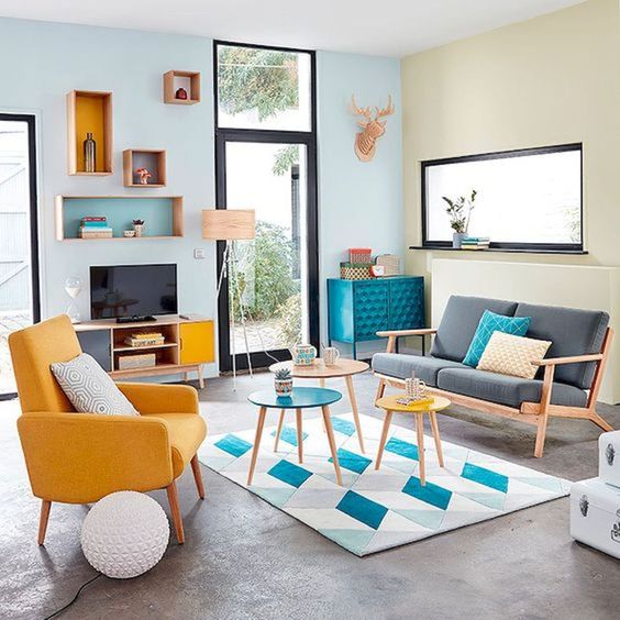 a bright retro living room in bold blue and yellow with a touch of geometric pattern