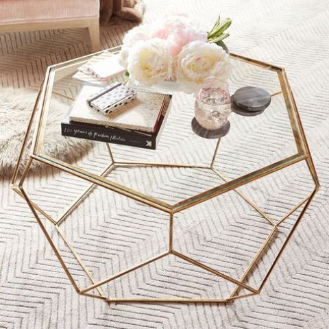 a geometric gold coffee table with a glass top looks catchy, glam and super cute